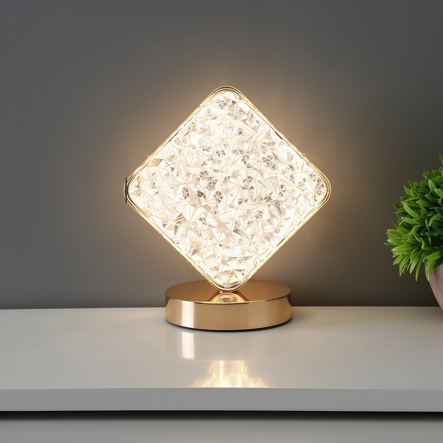Decorative table lamp with crystal-like design on a white surface.